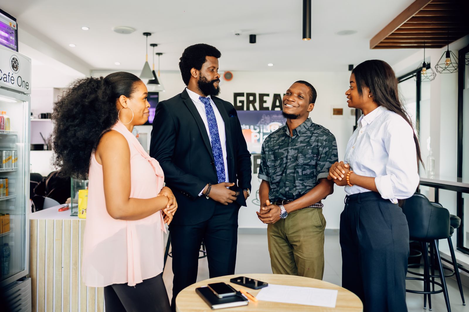 Four professionals talking in a Lagos office.